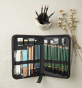 Pencil sketching kit editorial flat lay on linen